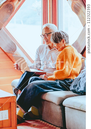 A picture of a senior couple doing a video call 112322393