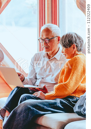 A picture of a senior couple doing a video call A picture of a senior couple doing a video call 112322409