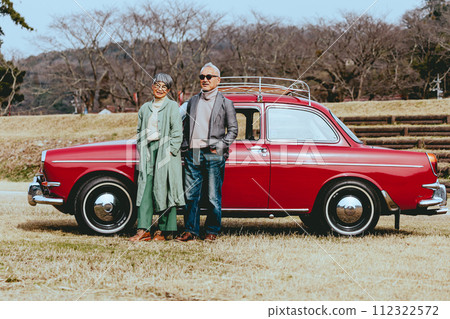 Photo of a stylish senior couple standing with their favorite car Photo of a stylish senior couple standing with their favorite car 112322572