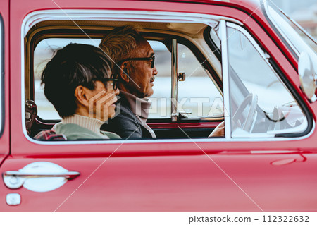 A picture of a senior couple driving in their car 112322632