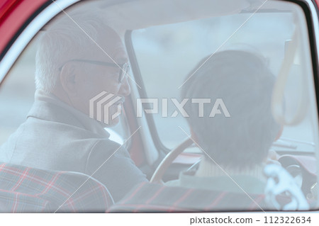 A picture of a senior couple driving in their car 112322634