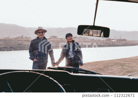 Photo of a senior couple holding hands at sunset 112322671