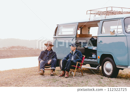 A senior couple sitting on an outdoor chair in the dusk 112322725