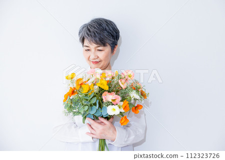 Senior women with flowers 112323726