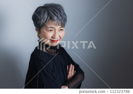 Senior woman smiling and folding arms Senior woman smiling and folding arms 112323786