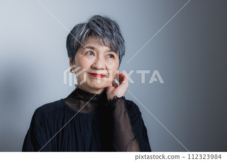 Senior woman smiling and folding arms Senior woman smiling and folding arms 112323984