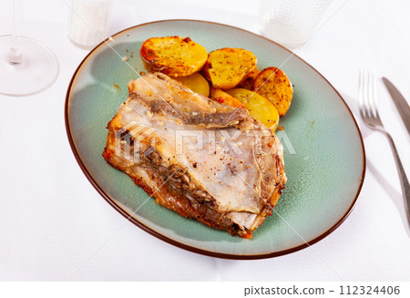 Roasted pork ribs served with fried baked potatoes Roasted pork ribs served with fried baked potatoes 112324406