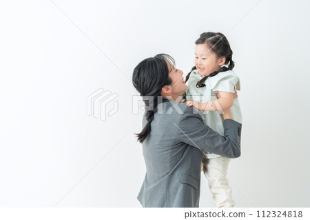 Middle business woman in a suit holding a child Middle business woman in a suit holding a child 112324818