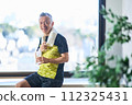 Senior man hydrating at the gym 112325431