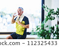 Senior man hydrating at the gym 112325433