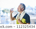 Senior man hydrating at the gym 112325434