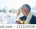 Senior man hydrating at the gym 112325436