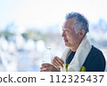 Senior man hydrating at the gym 112325437