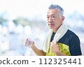 Senior man hydrating at the gym 112325441