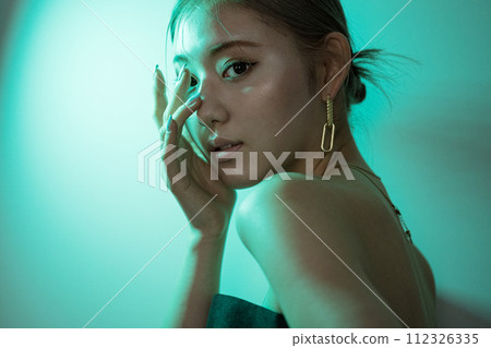 Female illuminated by green lights Female illuminated by green lights 112326335