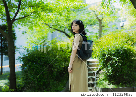 A woman walking in the park 112326953