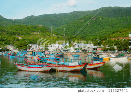 fishing boats on the shore, moored boats 112327441