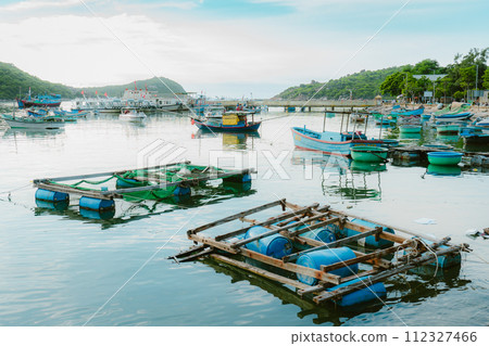 boats anchored on the shore, pebble beach 112327466