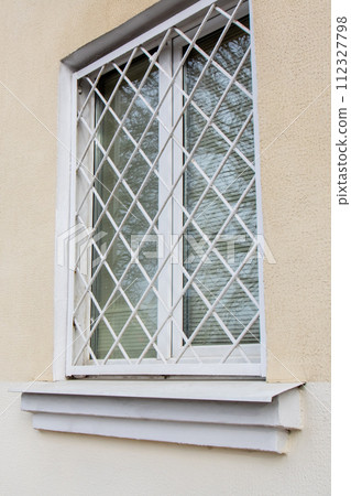 Grid on the window of moaning home Grid on the window of moaning home 112327798