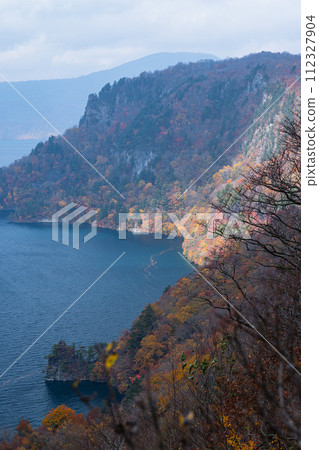 Japan: Goshiki Rocks and autumn leaves of Lake Towada and Mikura Peninsula seen from Kankodai in Okuse, Towada City, Aomori Prefecture 112327904