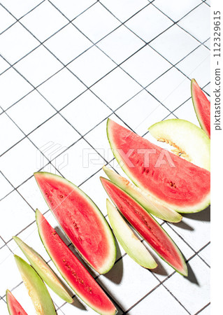 Summer concept with sliced melon and watermelon pieces put in a raw 112329615