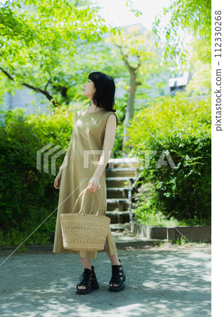 A woman walking in the park 112330268