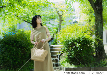 A woman walking in the park 112330275