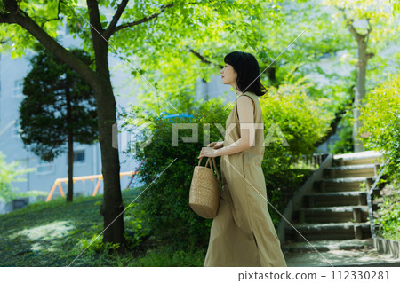 A woman walking in the park 112330281