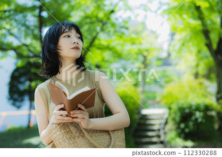 A woman relaxing in the park 112330288
