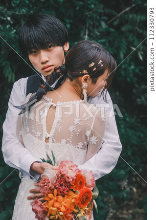 Bride and groom hugging at a resort Bride and groom hugging at a resort 112330793