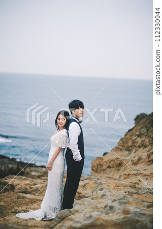 bride and groom cuddling on the beach bride and groom cuddling on the beach 112330944