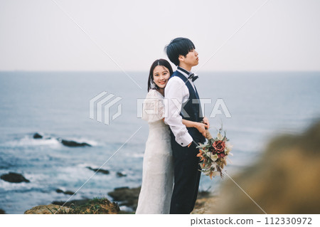 bride and groom cuddling on the beach bride and groom cuddling on the beach 112330972