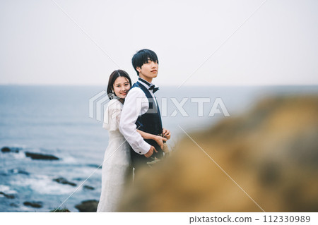 bride and groom cuddling on the beach bride and groom cuddling on the beach 112330989