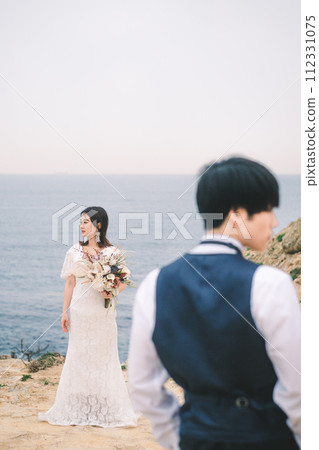 bride and groom on the beach 112331075