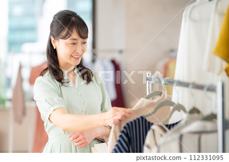 Middle-aged woman shopping at a store 112331095