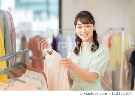 Middle-aged woman shopping at a store 112331104