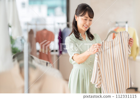 Middle-aged woman shopping at a store Middle-aged woman shopping at a store 112331115