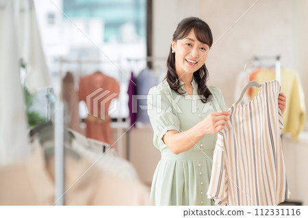 Middle-aged woman shopping at a store Middle-aged woman shopping at a store 112331116