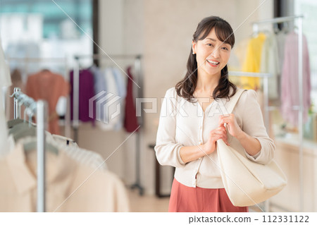 Middle-aged woman shopping at a store Middle-aged woman shopping at a store 112331122