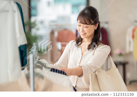 Middle-aged woman shopping at a store 112331130