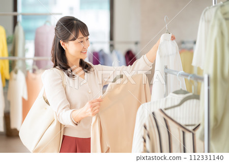 Middle-aged woman shopping at a store Middle-aged woman shopping at a store 112331140