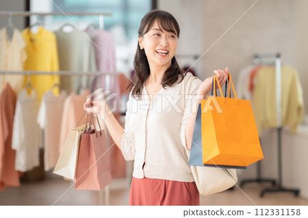 Middle-aged woman shopping at a store 112331158