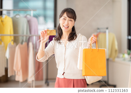 Middle-aged woman shopping at a store 112331163
