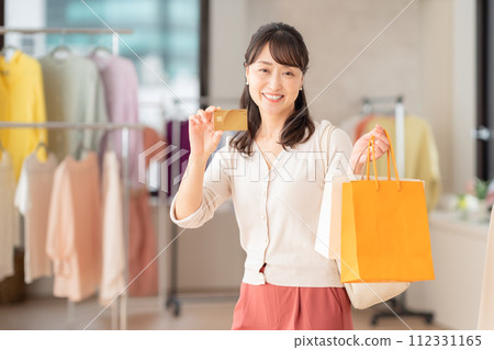 Middle-aged woman shopping at a store Middle-aged woman shopping at a store 112331165