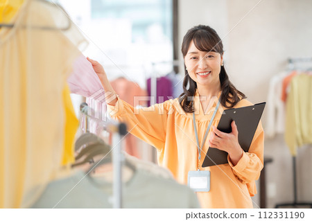 A middle-aged female clerk working at an apparel shop 112331190
