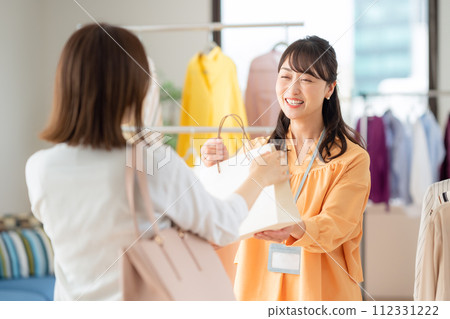 A middle-aged female clerk working at an apparel shop 112331222