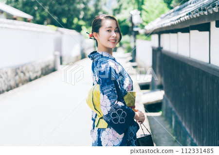 A woman in a yukata walking around the castle town of Hagi A woman in a yukata walking around the castle town of Hagi 112331485