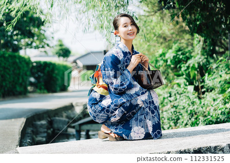 A woman in a yukata A woman in a yukata 112331525