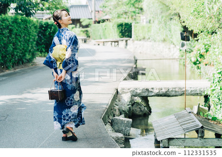 A woman in a yukata sightseeing in the town of Hagi A woman in a yukata sightseeing in the town of Hagi 112331535
