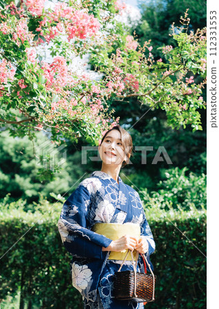 A lady in a yukata with flowers A lady in a yukata with flowers 112331553